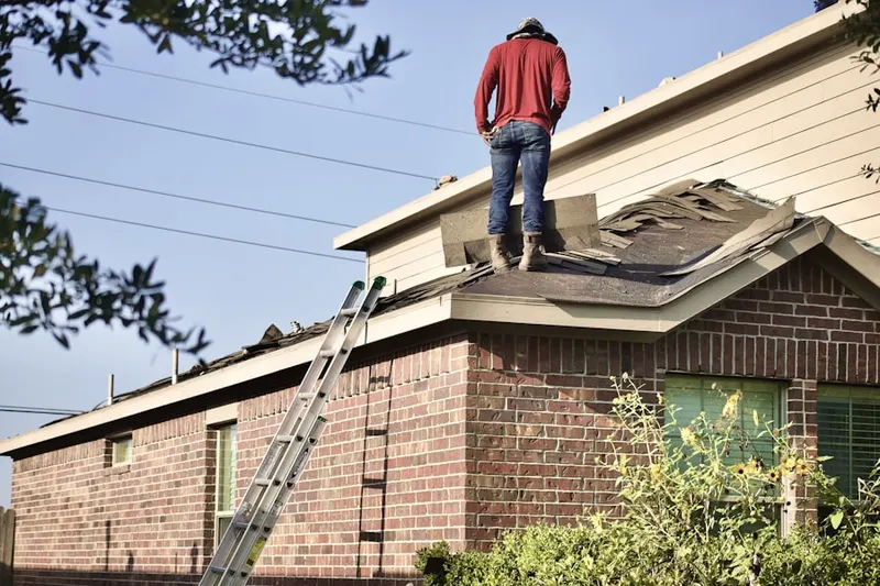 Professional roofer working on a residential roof in Sherrelwood